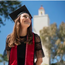 A girl in a graduation hat smiling
