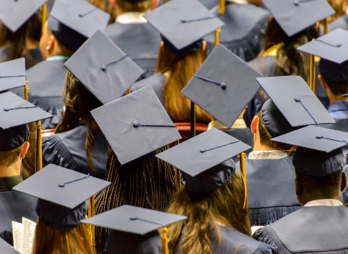 Back view of students headshot wearing graduation hats