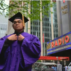 A boy wearing graduation gown