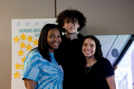 Bottom Line Ohio Advisor and students embracing in group shot.